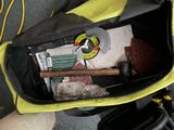 a yellow bag filled with tools and other items