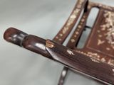 a small wooden chair with a book on top of it