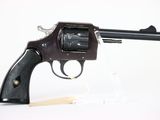 gun on a white background with a wooden stick in the foreground