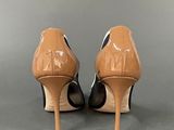 pair of nude colored high heeled shoes on grey background