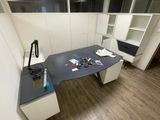 a desk with a computer on it in a room