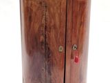 a small wooden cabinet with a black top on a white background