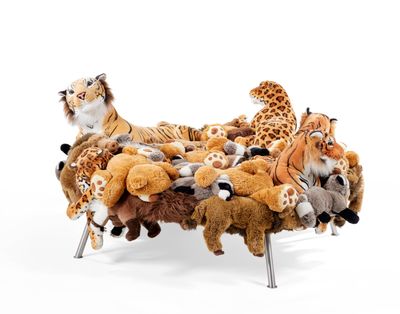 many stuffed animals sitting on a bench made out of stuffed animals