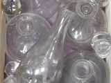 many empty glass bottles in a box on the floor
