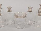four glass jars with silver lids and silver lids