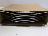 a stack of plates in a brown box on a table