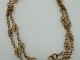 a close up of a gold chain bracelet with a clasp