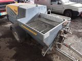 a small trailer with a machine attached to it