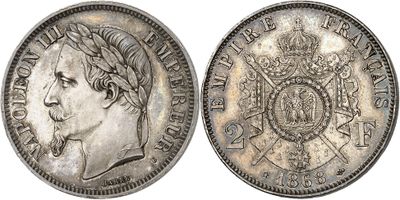 a silver coin with an image of a man in a crown on it