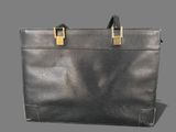 leather briefcase with gold handles on grey background with shadow