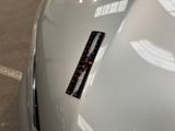 a sticker on the hood of a silver car
