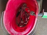 a red bucket with a red fire hydrant inside of it
