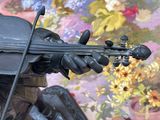 a statue of a man playing a violin in front of flowers