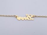 a gold plated bracelet with the word love written on it