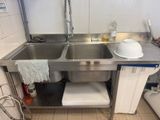 a stainless steel sink in a kitchen with a dishwasher on the counter