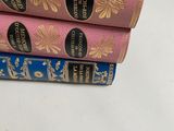three books stacked on top of each other on a table