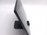 a close up of a laptop on a stand on a white surface