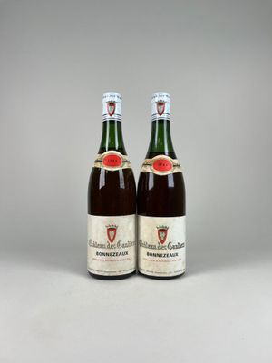 two bottles of wine sitting next to each other on a table
