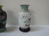 two vases that are sitting on a table
