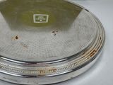 a silver plate with a silver lid on a white table