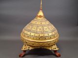 an image of a gold and silver box on a wooden stand