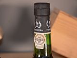 two bottles of wine that are sitting on a table