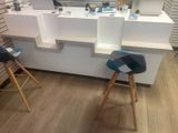 two stools that are sitting in front of a counter