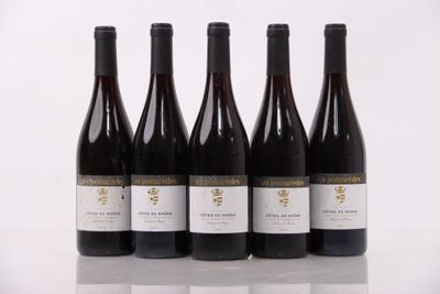 four bottles of wine are lined up on a table