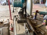 a man that is working on a machine in a garage