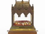 an old fashioned clock with a glass case on a wooden stand