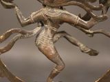 an image of a bronze statue of a person on a wooden base