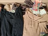 a box full of clothes and a book on the floor