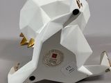 a white origami elephant with a gold crown on it ' s head