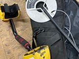 a metal detector and a bag on the floor