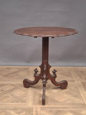 a small table with a wooden top on a parquet floor