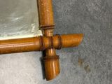 a mirror with a wooden frame on the floor