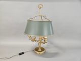 brass table lamp with a green shade and a gold base