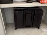a black suitcase sitting on top of a shelf in a closet