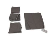 four pieces of cloth on a white surface with a remote control