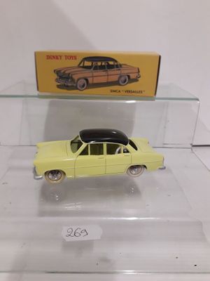 a yellow toy car on display in a clear case