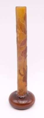 a glass vase with a brown base on a white background