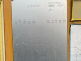 a metal plaque on the side of a yellow machine