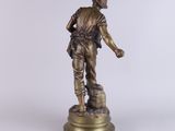 bronze figurine of a soldier on a pedestal on a white background