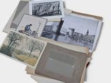 a pile of old photographs on a white surface