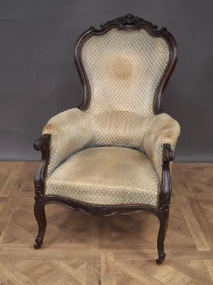 an old fashioned chair on a wooden floor in a room