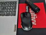 a mouse and a mouse pad on a desk next to a laptop