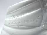 a close up of a white vase with writing on it
