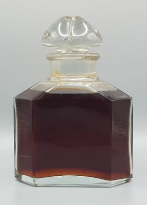 a glass bottle with a brown liquid inside of it