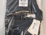black t - shirt wrapped in plastic with a barcode on it