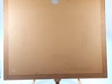 a picture of a wooden easel with a brown canvas on it
